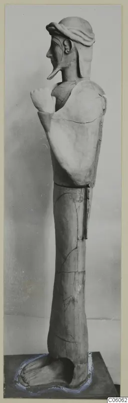 Terracotta Proto-Cypriote II, a tall standing statue shown in side view on a plinth