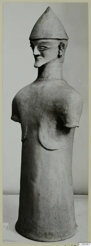 Terracotta Proto-Cypriote I, a tall standing figure with a conical hat and stumps where the arms were
