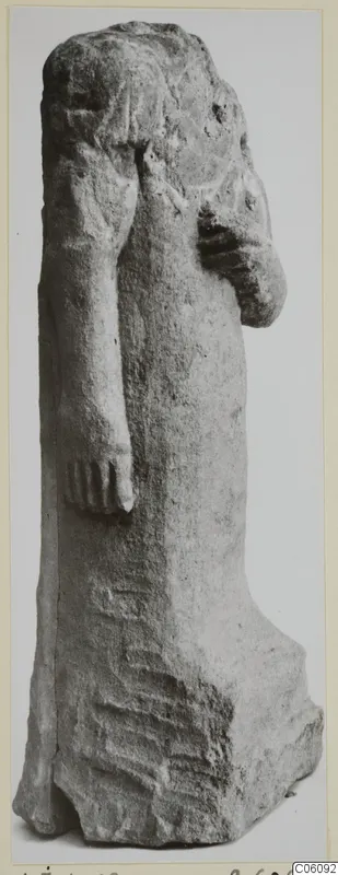 Limestone statuette of a standing figure with one arm raised to the chest, from Ayia Irini, photographed alone