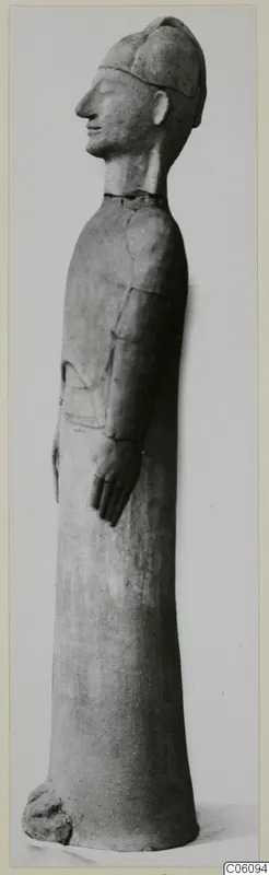 Tall terracotta standing figure in profile, wearing a cap, from Ayia Irini
