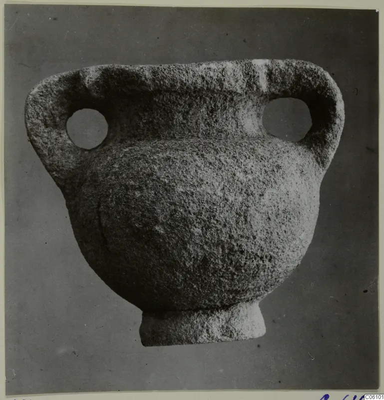 Stone amphora with two loop handles, each pierced by a large round hole, and a short foot
