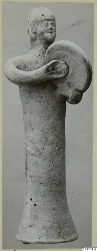 Terracotta statuette of a standing figure holding a round shield across its body, from Ayia Irini
