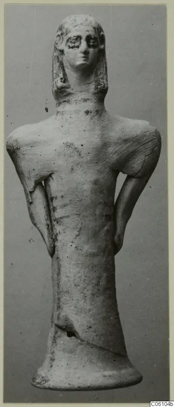 Terracotta figurine of a standing figure with arms at its sides, shown frontally against a grey background