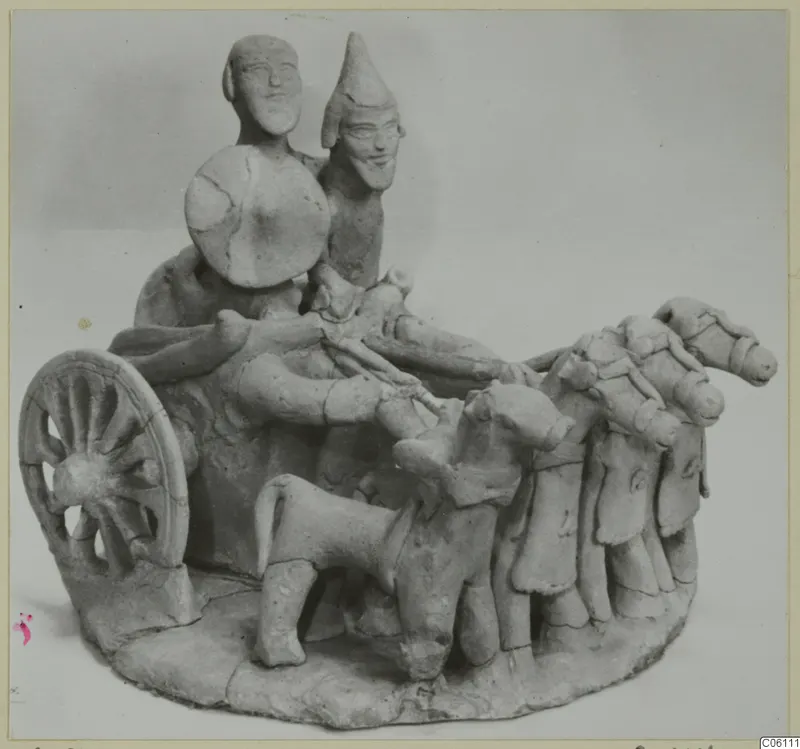 Terracotta figurine of a chariot with two riders, a round shield and a team of harnessed horses, from Ayia Irini