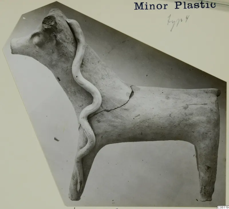 Terracotta figurine of a horned animal, probably cattle, with a wavy clay strip across its body
