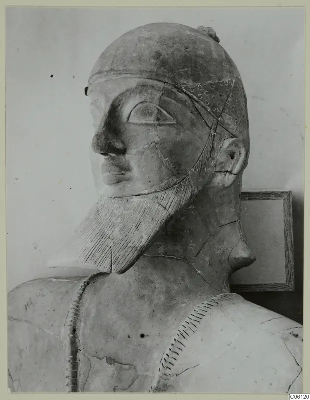 Terracotta Neo-Cypriote bust of a bearded figure with a dotted cap, shown in three-quarter view