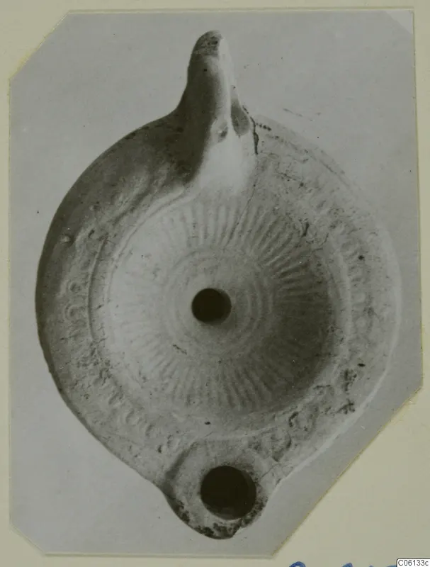 Terracotta oil lamp from Soli with a radiating pattern on the disc, seen from above.