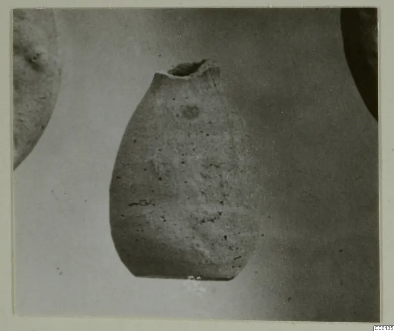Hellenistic wares: a pottery vessel with a broken neck, shown against a plain light background