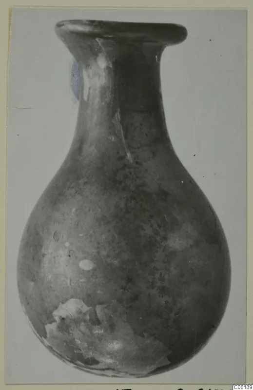 Blown glass vessel with a flared rim, long neck and rounded body, from Idalion