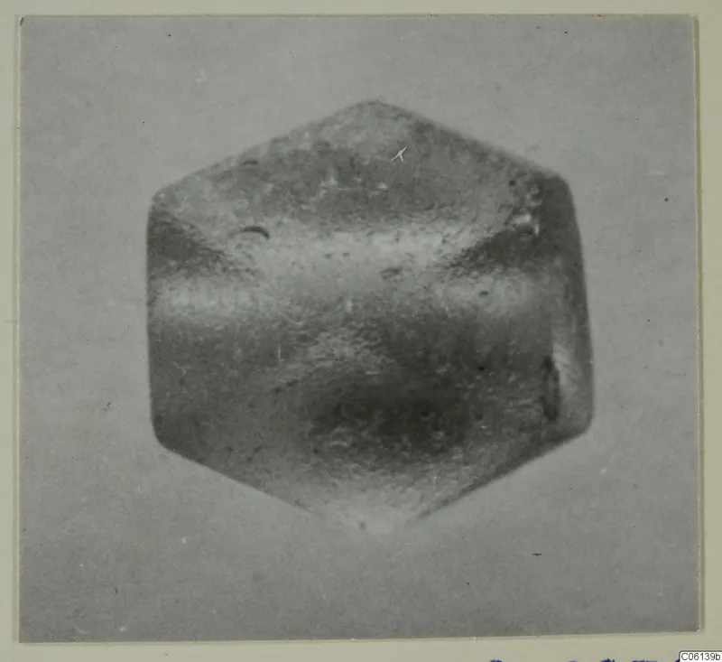 Close-up photograph of a small hexagonal object with a pointed top and bottom, from the Idalion finds series