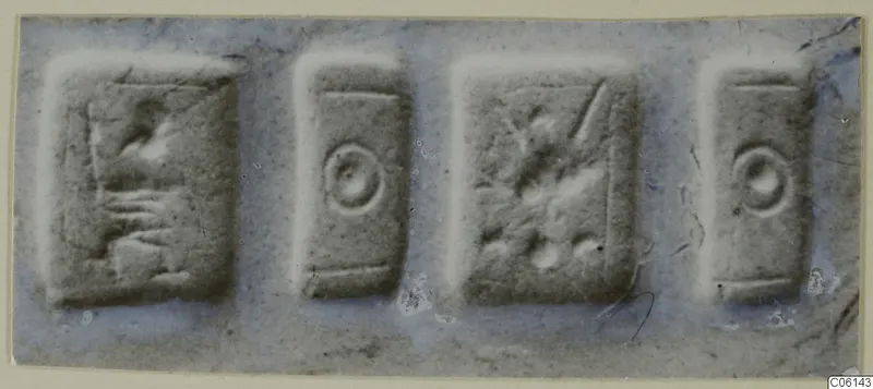 Four rectangular seal faces in a row, each with a simple incised motif.