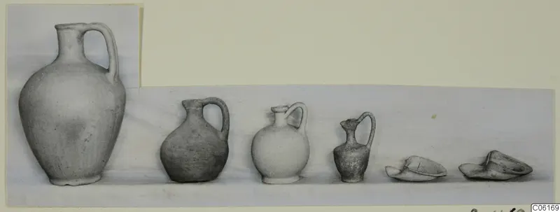 Row of pottery from Vouni Tombs 6 and 12: jugs of decreasing size and two broken bowls