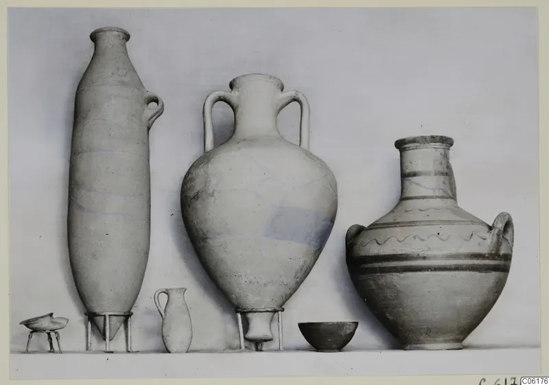 Pottery vessels from Tomb 15 at Vouni, set out in a row against a plain backdrop.