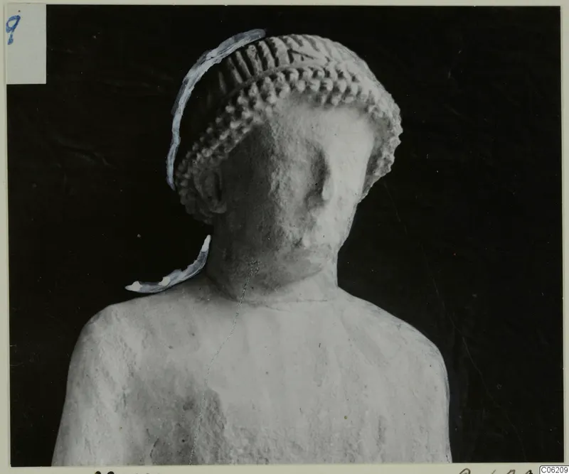 Limestone statue from Kition, head and upper torso, with a ridged cylindrical headdress