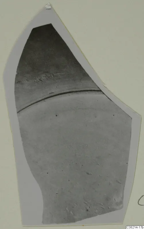 Pottery sherd with a raised ridge across its middle, shown on a light card mount; Roman Wares I-III