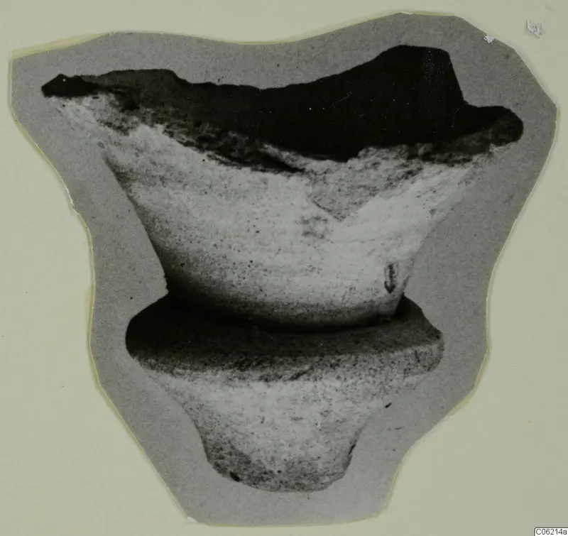Broken pale object with a flared open top, a ring-shaped collar and a narrow foot, shown on grey card