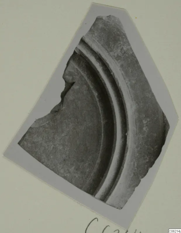 Curved sherd with raised concentric moulded ridges, shown on a grey photo card mount