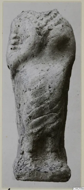 Terracotta figurine fragment from Vouni, standing upright with a face-like profile at upper left