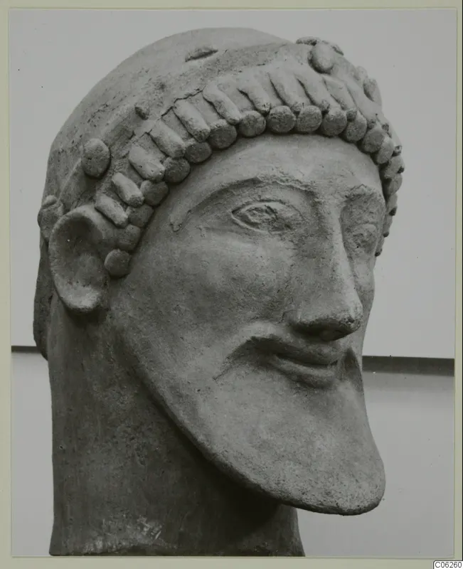 Bearded head sculpture from Mersinaki, shown in three-quarter view against a pale backdrop