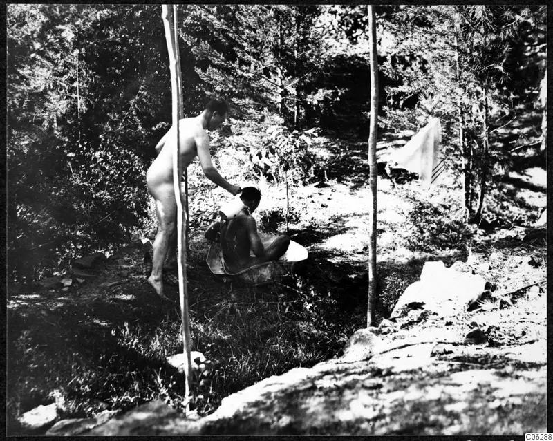 Two men bathing in a forest clearing at Machairas.