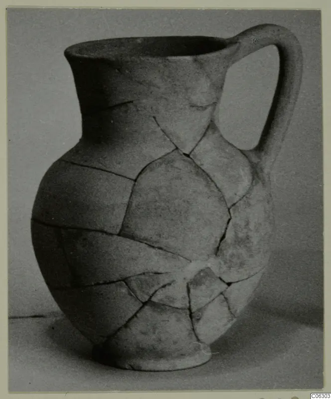 Pottery Plain White VI jug with a single handle, reassembled from broken pieces