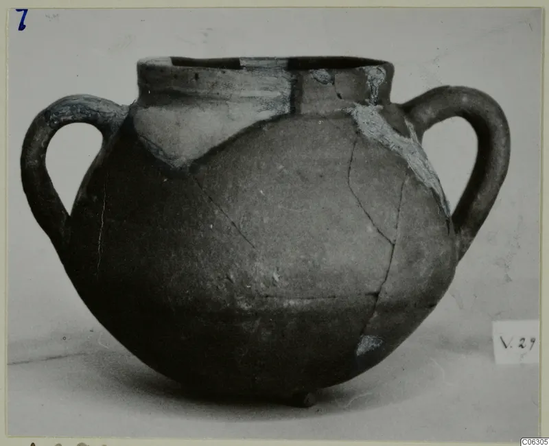 Globular two-handled coarse ware jar with cracks and pale filled areas