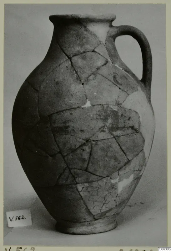 Pottery Plain White VI jug (V.562), reassembled from broken pieces, with a single loop handle and ring base