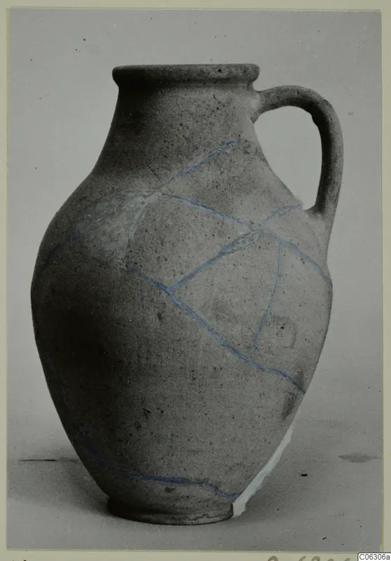 Pottery Plain White VI jug with a single handle, with blue lines marking repaired breaks across its body