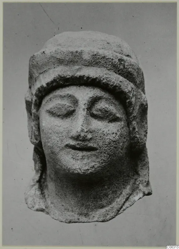 Limestone head of a figure with closed eyes and a close-fitting cap, from Kition