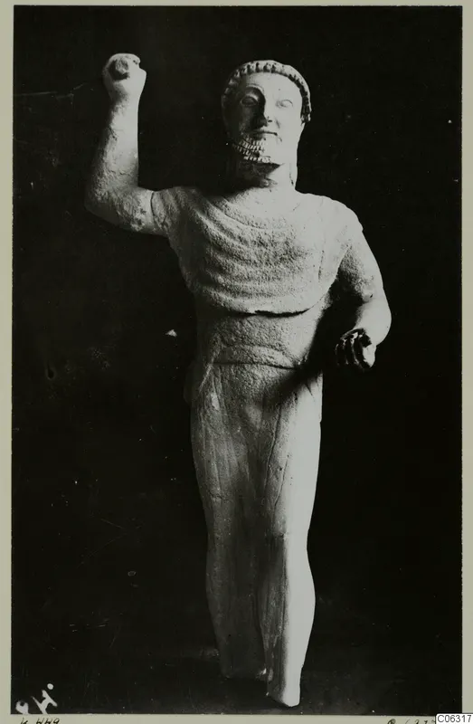 Limestone Cypro-Greek I statuette of a standing bearded male figure with one fist raised, from Kition