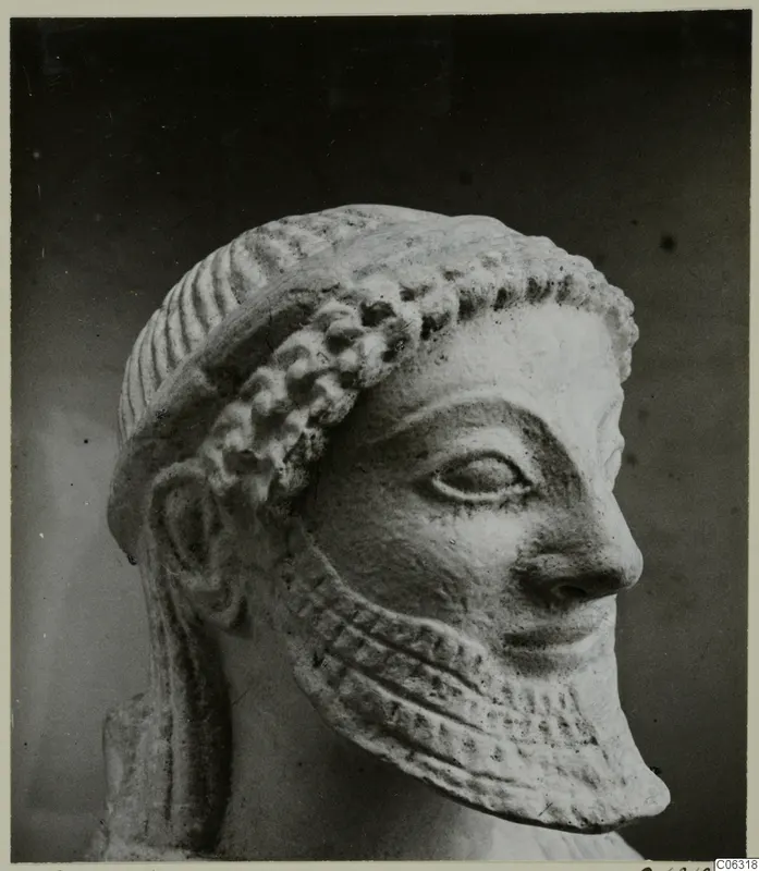 Limestone head from Kition, shown in right profile against a dark background