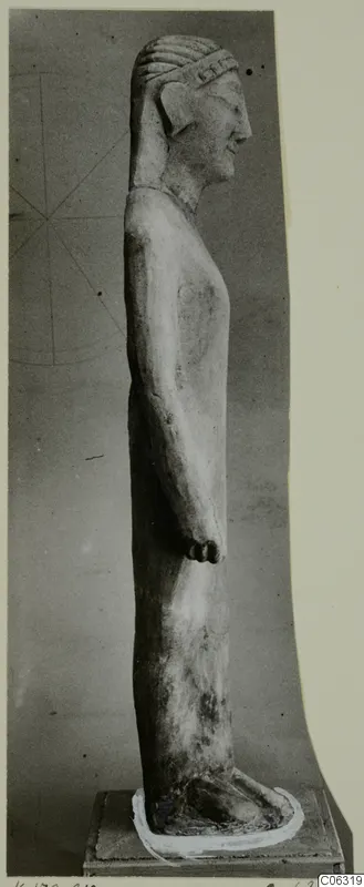 Limestone statue of a standing figure in side view on a square base, from Kition