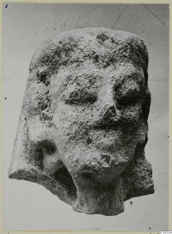 Limestone head fragment from Kition with worn face, broken at the back and lower left