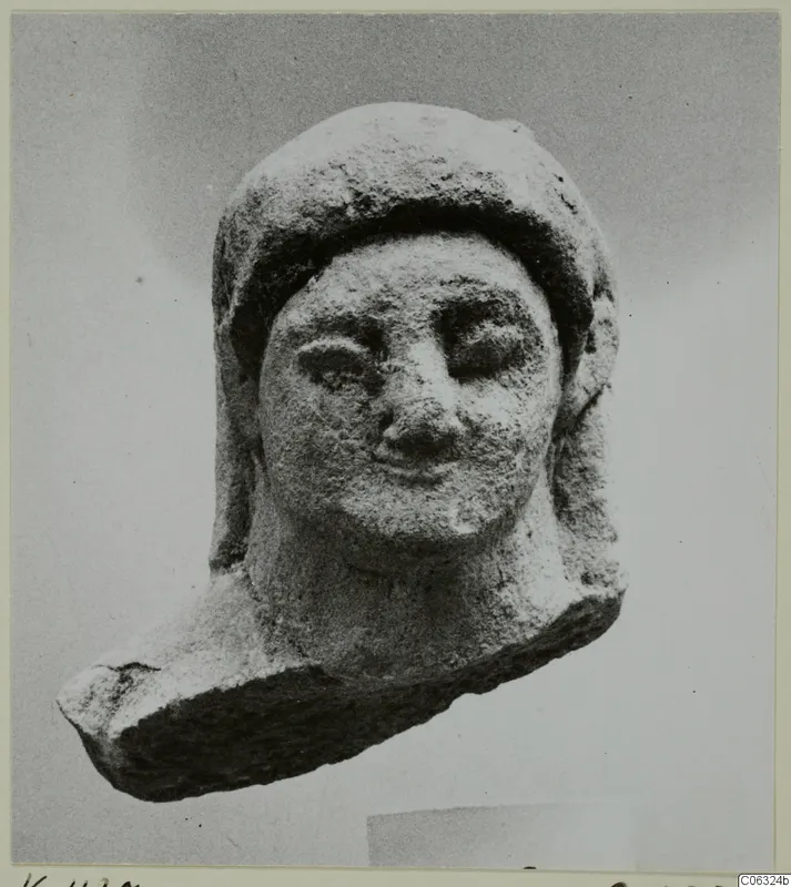 Limestone head statuette from Kition, face turned toward the viewer, with a close-fitting head covering