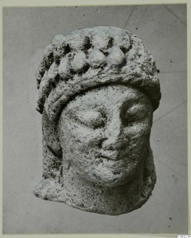 Limestone head fragment from Kition, shown from the front, with a band of rounded knobs across its headdress