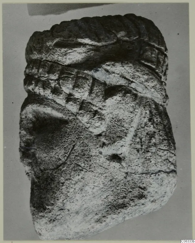 Limestone sculpture fragment from Vouni with a ridged band and incised diagonal lines on a rounded form