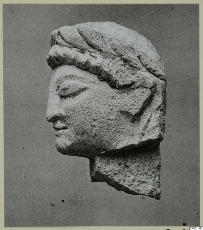 Limestone head statuette from Kition, shown in left profile with closed eyes and a band across the hair