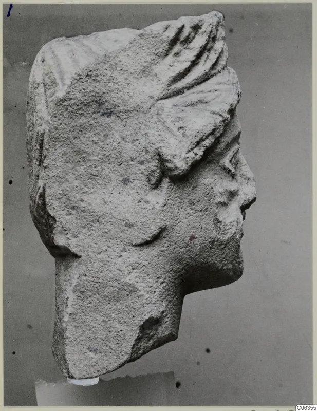 Limestone head fragment from Kition, in profile facing right, with ridged hair and a broken neck
