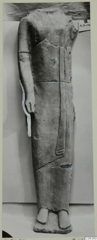 Headless limestone standing figure in a long garment, from Kition