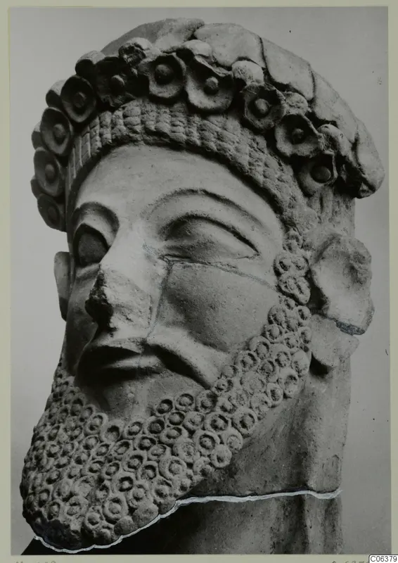 Terracotta head of a bearded male statue wearing a crown of rosettes, shown in close view