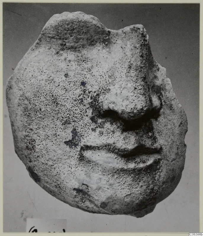 Limestone fragment of a face from Vouni, showing the nose and mouth