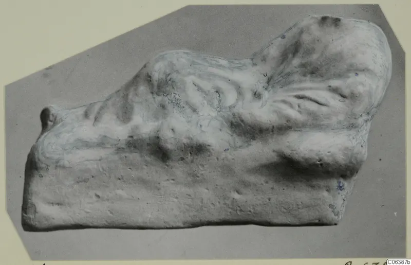 Pale fragment of a figurine from Vouni, with a rounded knob at the left end and a flat underside