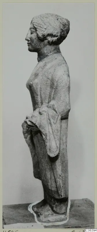 Limestone statuette of a standing female figure seen in profile, facing left, from Vouni