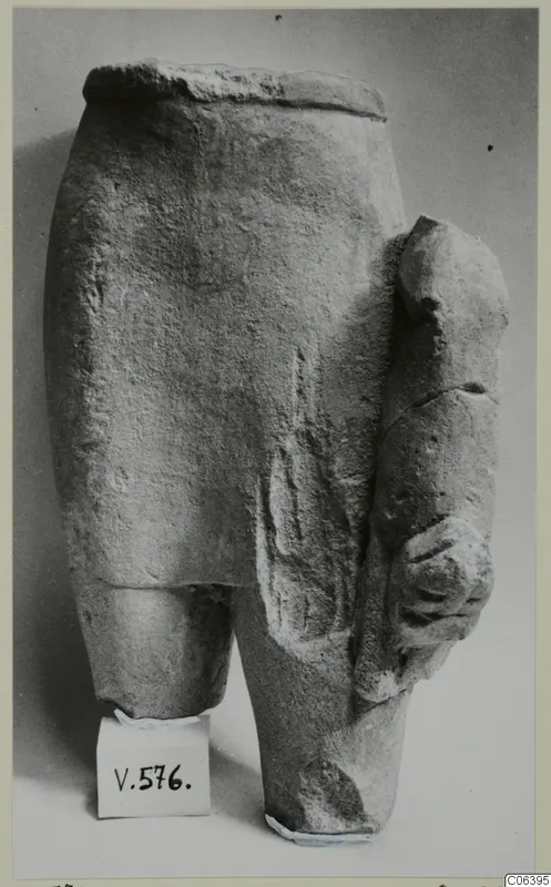 Limestone sculpture fragment, lower part of a figure with an arm projecting at the side, from Vouni