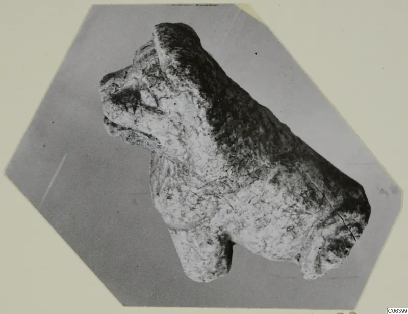 Limestone figurine of a four-legged animal from Vouni, shown in side profile against a grey backdrop