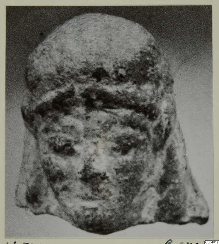 Front view of a small head with a broad band across the brow and a broken lower edge, mounted on a card