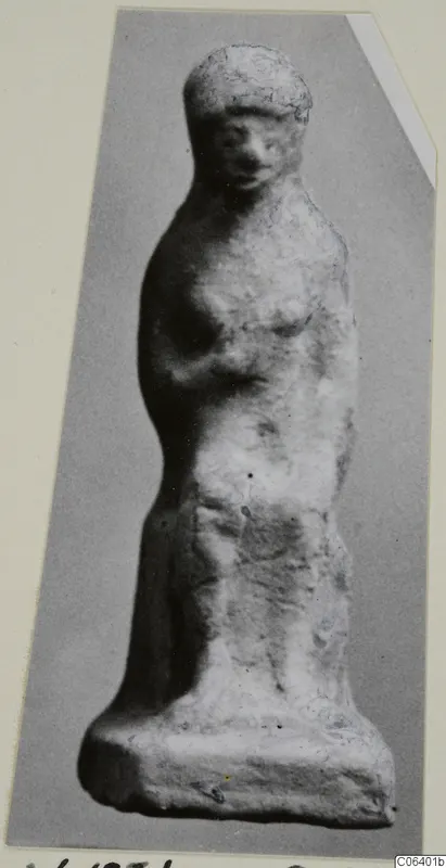 Terracotta figurine of a standing female figure, shown frontally on a flat base, from Vouni