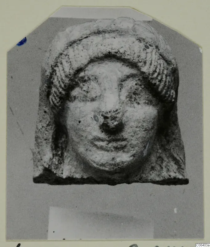 Terracotta head fragment with ridged hair framing a broad face, from Vouni