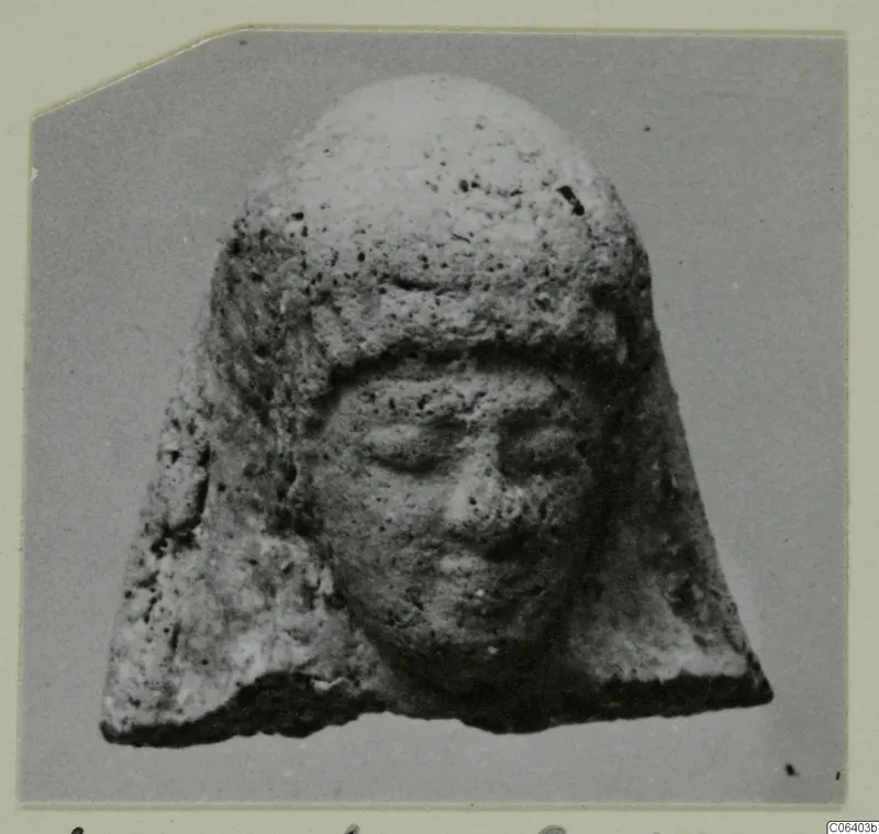 Small head of a figure in a close-fitting cap, with a rounded face, from Vouni