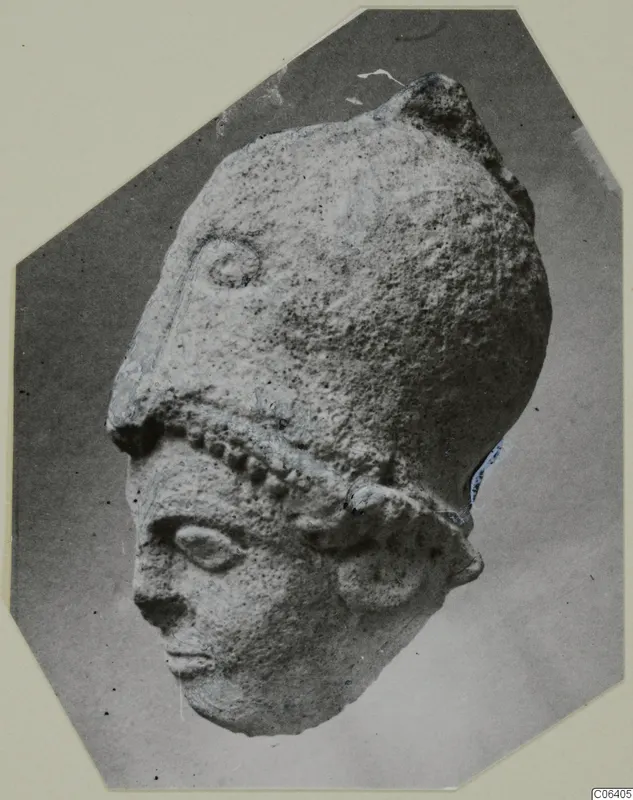 Limestone head from Vouni with a tall headdress, photographed on a card mount